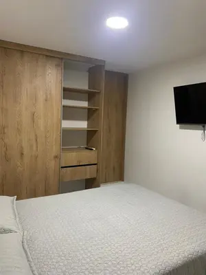 a bedroom with a bed and a flat screen tv at Apartamento Alameda del Rio in Barranquilla