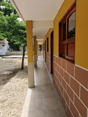 an empty hallway of a school building with yellow walls at Hospedaje Mango y Mar Habitaciones in Coveñas