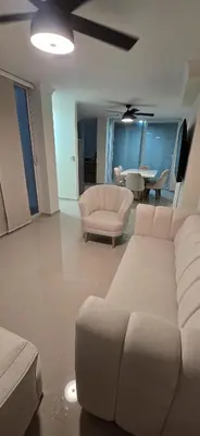 a living room with white furniture and a table at Casa 4 Barrio El Prado in Barranquilla