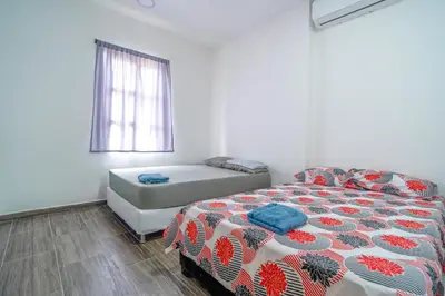 a bedroom with a bed and a window at Casa Vianca Beach in Estación El Salto