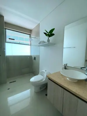 a bathroom with a sink and a toilet and a mirror at Sonesta Apartamento en Cartagena in Cartagena de Indias