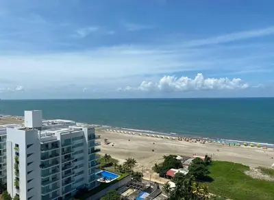 a view of a beach with a building and the ocean at Sonesta Apartamento en Cartagena in Cartagena de Indias