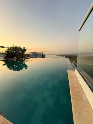 a swimming pool with a view of the ocean at Exclusivo Apto En Dominique Cartagena in Cartagena de Indias