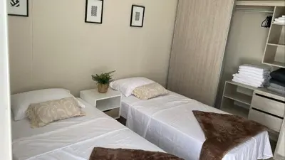 a room with two beds and a mirror at Exclusivo Apto En Dominique Cartagena in Cartagena de Indias
