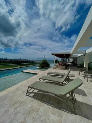 a group of lounge chairs sitting on a patio at Exclusivo Apto En Dominique Cartagena in Cartagena de Indias