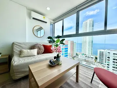 a living room with a couch and a large window at magnoloft1104 in Cartagena de Indias