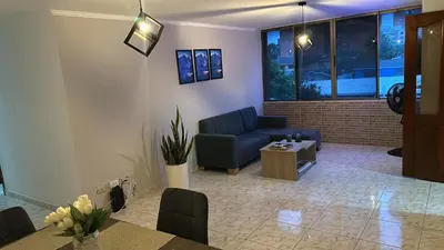 a living room with a couch and a table at Apartamento 84 - 2 habitaciones in Barranquilla