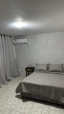a bedroom with a bed in a room with curtains at Apartamento 84 - 2 habitaciones in Barranquilla