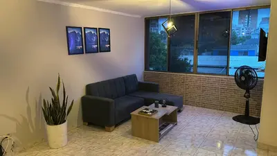 a living room with a couch and a table at Apartamento 84 - 2 habitaciones in Barranquilla