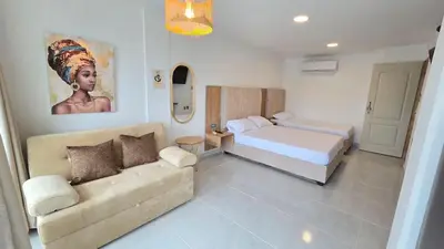 a bedroom with a bed and a couch in a room at Loft MR1-4G facing the sea in a high level neighborhood in Cartagena de Indias