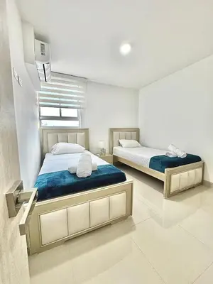 a bedroom with two beds and a window at Lujoso alojamiento empresarial en Cartagena in Cartagena de Indias