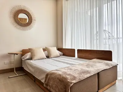 a bed in a room with a large window at Spectacular Beachfront Apartment in Cartagena de Indias