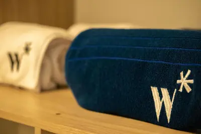 a blue blanket on a table with a bed in the background at Serene Bay by Wynwood House in Cartagena de Indias