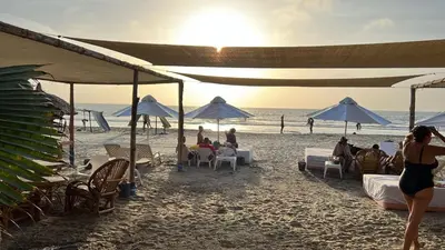 a group of people sitting in chairs on a beach at Playa Banana Manzanillo del Mar in Cartagena de Indias