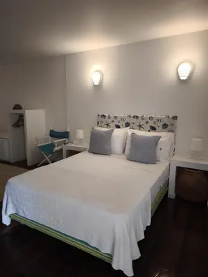 a bedroom with a large white bed with two pillows at Playa Banana Manzanillo del Mar in Cartagena de Indias
