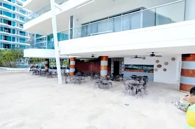 a patio with chairs and tables in a building at Apartamento de Ensueño!! Sonesta Cartagena Salida Playa Vistas WOW Morros in Cartagena de Indias