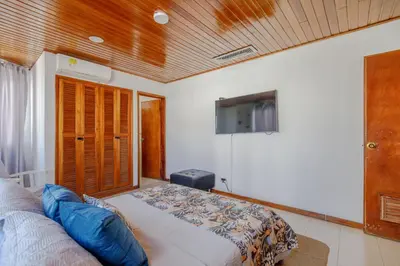 a bedroom with a bed and a flat screen tv at Spacious apartment in Bocagrande near the sea in Cartagena de Indias