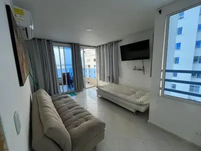 a living room with a couch and a flat screen tv at Bahía Caribe in Estación El Salto