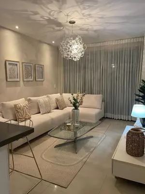 a living room with a white couch and a chandelier at Mistral Exclusive oceanfront apartment with balcony in Cartagena de Indias