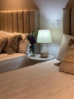 a bedroom with a bed with a lamp and flowers at Mistral Exclusive oceanfront apartment with balcony in Cartagena de Indias