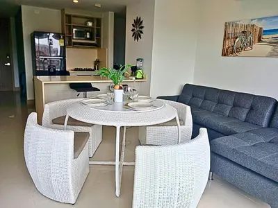 a living room with a table and a couch at Apartamento en condominio de lujo morros eco. in Cartagena de Indias