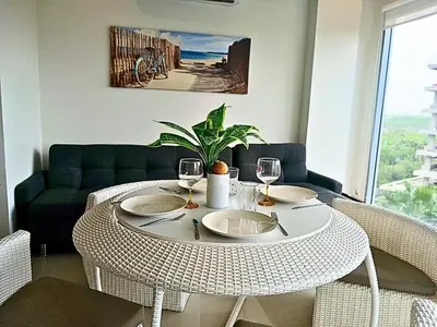 a table with two wine glasses and a plant on it at Apartamento en condominio de lujo morros eco. in Cartagena de Indias