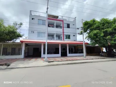 a building on the corner of a street at Hotel Madeleine Inn Sede Sur in Barranquilla