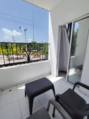a balcony with a chair and a window with a view at Hotel Madeleine Inn Sede Sur in Barranquilla