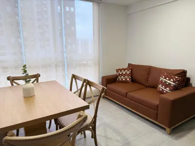 a living room with a couch and a table at APTO LODGE - Confortable y acogedor apartamento al norte de Barranquilla vía a Puerto Colombia in Barranquilla