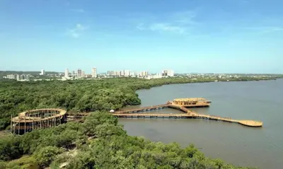 a bridge over a river with a city in the background at APTO LODGE - Confortable y acogedor apartamento al norte de Barranquilla vía a Puerto Colombia in Barranquilla