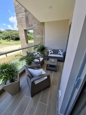 a living room with couches and plants on a balcony at Baia Kristal - Vacaciones Cartagena Colombia in Cartagena de Indias