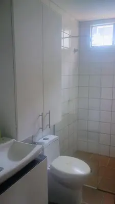 a white bathroom with a toilet and a sink at Balcones en Bello Horizonte in Santa Marta