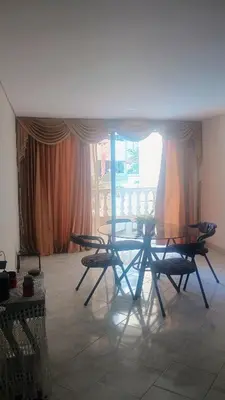 a table and chairs in a room with a window at Balcones en Bello Horizonte in Santa Marta