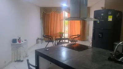 a kitchen with a black refrigerator and a table at Balcones en Bello Horizonte in Santa Marta