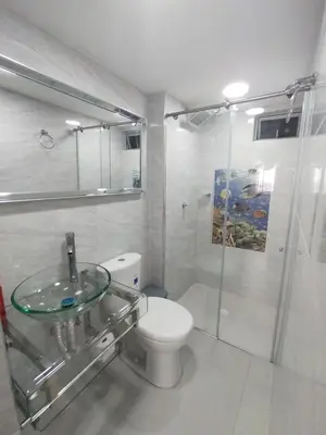a bathroom with a glass sink and a toilet at Sol y Brisa 811 in Cartagena de Indias