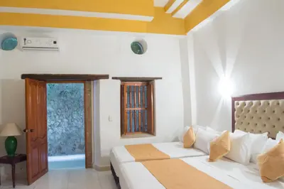 a bedroom with a bed and a window at Hotel Casa Tere in Cartagena de Indias