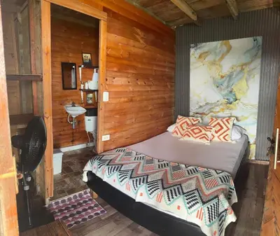a bedroom with a bed with a large painting on the wall at Chiki luki in Baru