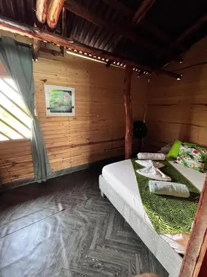 a bedroom with two beds in a wooden room at Chiki luki in Baru