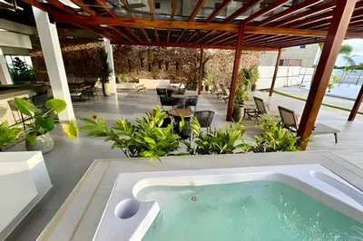 an outdoor pool with a hot tub on a patio at Vista a Laguna de Kristal + Bote inflable in Los Arrayanes