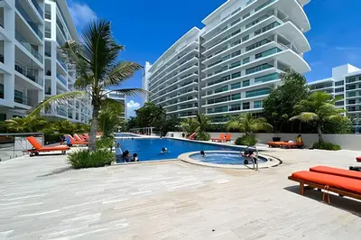 a swimming pool in front of a large building at 1 Dormitorio y terraza Morros. Vista mar in Cartagena de Indias