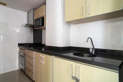 a kitchen with wooden cabinets and a sink at Apartamento 1 dormitorio Morros. Vista Mar y Acceso Playa in Cartagena de Indias