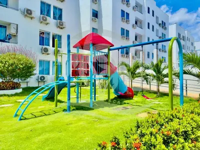 a playground in a park in front of a building at Vacaciones Inolvidables in Coveñas
