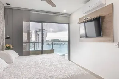 a bedroom with a bed and a tv and a window at Apartment With Beautiful View In Infinitum in Cartagena de Indias
