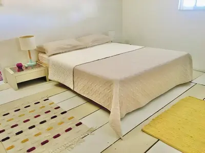 a bedroom with a bed and a rug at Cartagena - stunning location in walled city in Cartagena de Indias