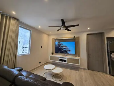 a living room with a couch and a flat screen tv at Moderno apartamento vista al mar y al lago piso 10 in Cartagena de Indias