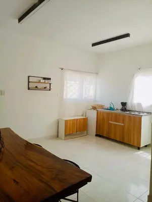 a kitchen with a wooden table in a room at Villa Colibrí in Santa Marta