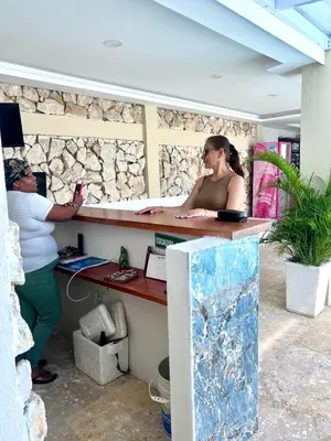 two women standing at a counter in a stone wall at Open Sea Hotel Cartagena - Frente al mar in Cartagena de Indias