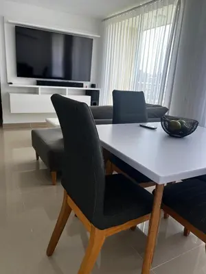 a living room with a table and a couch at Duplex Penthouse Rooftop Lounge in Barranquilla