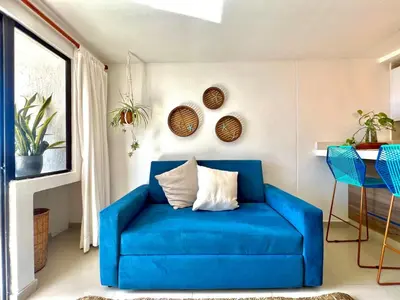 a blue couch sitting in a living room at Luxury mediterranean Suite in Cartagena de Indias