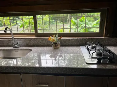 a kitchen with a stove and a sink and a window at Chalet Palo DAgua in Turbaco